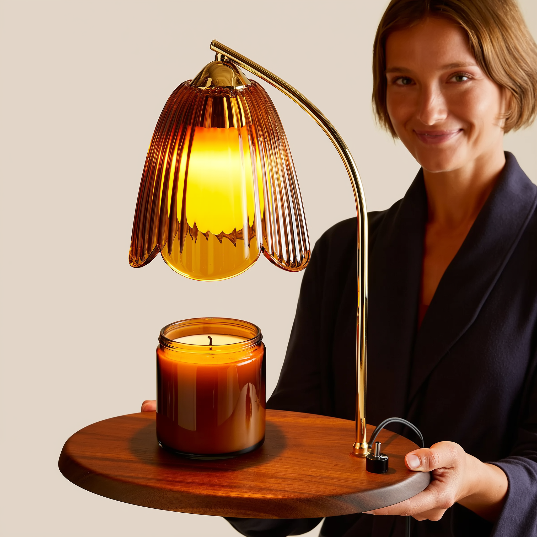 Aromatherapy wax warmer lamp on a nightstand beside a book and folded blanket