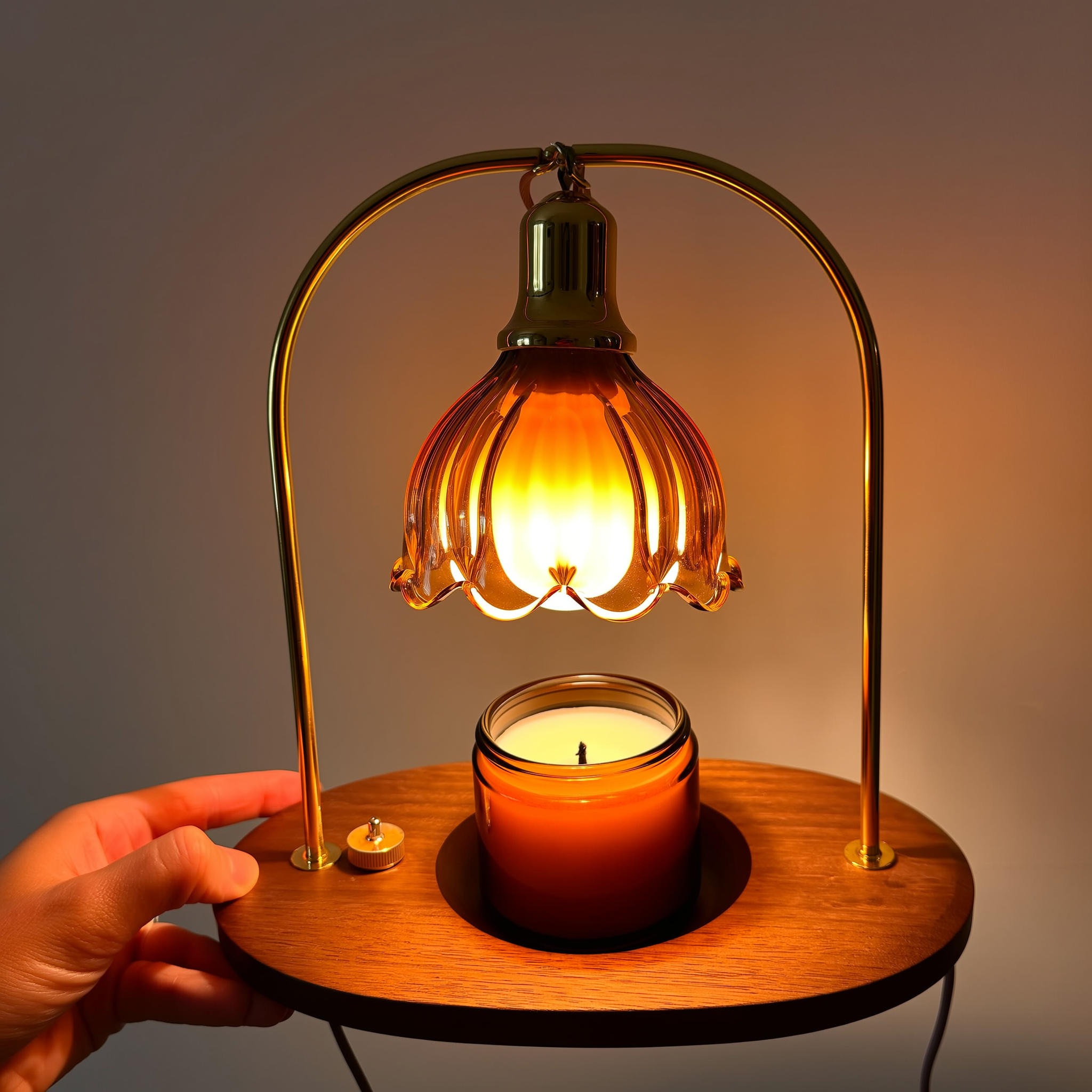 Fluted amber-glass wax warmer lamp melting a candle from above, completely flame-free