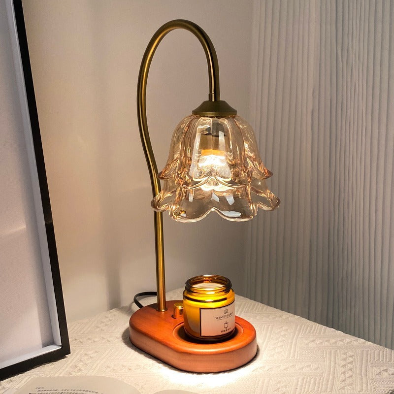 Ember & Co flameless candle warmer lamp casting soft amber light in a dim room